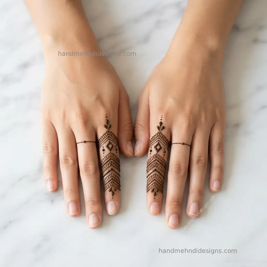 Minimal finger mehndi featuring small diamond shapes, parallel lines, and dots across two fingers.