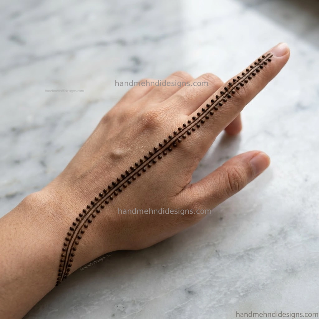 Straight forward diagonal line trail back hand mehndi with dot accents