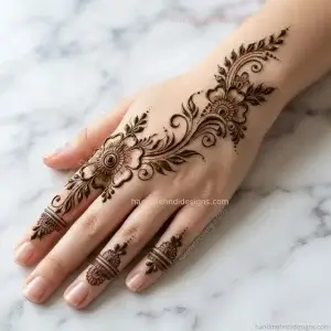 Easy diagonal floral back hand mehndi with two flowers, leafy stems, buds, and dot accents