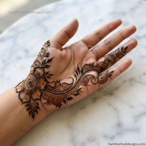 Side palm mehndi with a narrow floral vine, tiny blossoms, and leafy details along the outer edge of the hand.