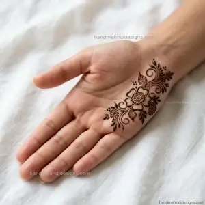 Front palm showing a small floral motif covering one half with open negative space on the other side