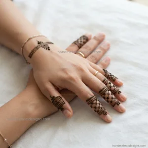 Simple back hand finger decoration with fine lattice details, dots and slim bands
