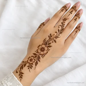 Simple back hand floral pattern extending from the wrist with leafy trails and dotted accents