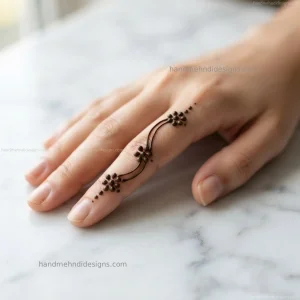 Simple finger floral dot mehndi with tiny dotted flowers connected along the finger