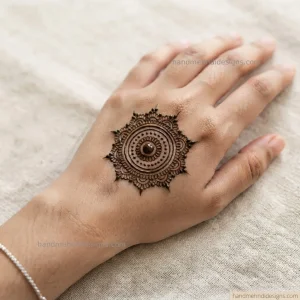 Simple mandala dot mehndi with concentric circles of tiny dots on the back hand