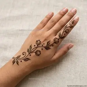 Easy beginner back hand bel mehndi with a simple diagonal vine, pointed leaves, and small dots.